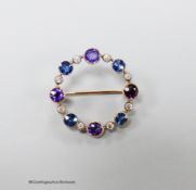 An early 20th century yellow metal, amethyst, sapphire and diamond chip set openwork circular