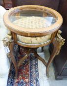 An early 20th century circular bijouterie table with applied cast gilt metal figural mounts, 68cm