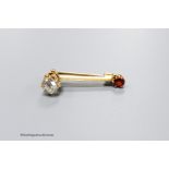 A small yellow metal, cushion cut diamond and garnet? set two stone bar brooch, 30mm, gross weight