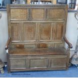 A 17th century panelled oak settle, with later seat, length 142cm, depth 40cm, height 152cm