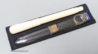 An early 20th century ivory eye dropper pen and an enamelled white metal mounted paperknife