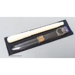 An early 20th century ivory eye dropper pen and an enamelled white metal mounted paperknife