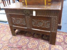 A 17th century carved boarded and panelled oak chest with rectangular moulded top, length 97cm,