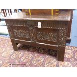 A 17th century carved boarded and panelled oak chest with rectangular moulded top, length 97cm,