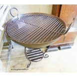 A wrought iron garden fire pit on stand with grill, diameter 69cm, height 65cm