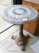 A Victorian Aesthetic movement cast iron circular garden table in the manner of Christopher
