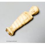 A 19th century or earlier carved ivory and lapis lazuli swaddling infant seal, length 10cm