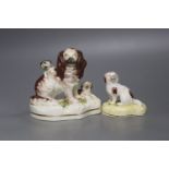 A Victorian Staffordshire Spaniels group and a small porcelain dog, tallest 13cm