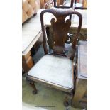 A set of four George I walnut dining chairs on front cabriole legs