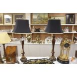 A pair of carved and giltwood table lamps and shades, overall height 100cm