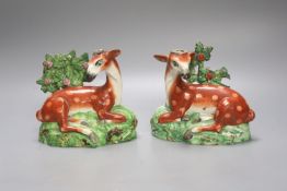 A pair of early 19th century Staffordshire pearlware models of deer, height 13cm