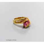 A modern 18k gold, emerald cut pink sapphire set dress ring, with graduated baguette cut diamond
