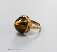 A 9ct and cabochon tiger's eye quartz set dress ring, size O, gross 5.4 grams.
