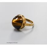 A 9ct and cabochon tiger's eye quartz set dress ring, size O, gross 5.4 grams.