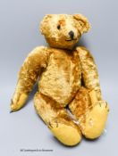 A cotton plush teddy bear, 'Bingo', straw-filled,with boot button eyes, long snout and humped