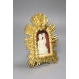 A carved ivory relief figure of a maiden emblematic of agriculture, in a giltwood sunburst frame,