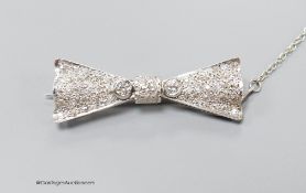 A modern Art Deco style 18ct white gold and diamond encrusted 'bow tie' brooch, 40mm, gross 7.1