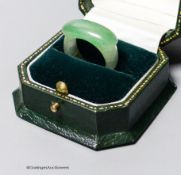 A Chinese jadeite ring, 19th/20th century,the carver skilfully incorporating the green inclusion in