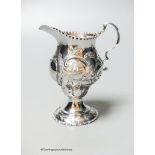 A George III silver helmet cream jug, with later embossed decoration, London, 1778, 10.6cm, 83