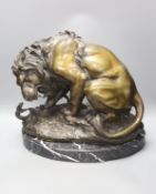 After Antoine-Louis Barye. A reproduction bronze of a tiger attacking a serpent, on a marble