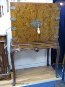 A Queen Anne style carved burr walnut cocktail cabinet on stand, width 100cm, depth 58cm, height