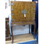 A Queen Anne style carved burr walnut cocktail cabinet on stand, width 100cm, depth 58cm, height