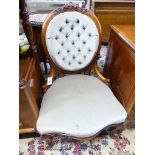 A Victorian walnut spoon back nursing chair upholstered in buttoned pale green dralon