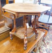 A late Victorian octagonal walnut aesthetic movement two tier centre table, width 68cm, depth 68cm,