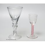 An early 18th century light baluster wine glass and an English red and white colour twist cordial