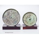 Two Chinese archaic bronze circular mirrors, etc., largest 11cm