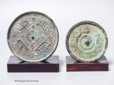 Two Chinese archaic bronze circular mirrors, etc., largest 11cm