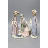 A Lladro figure of a girl with a doll, another girl with a doll in a toy cart and a matador,