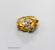 A 1970's? 18ct gold and seven stone diamond set modernist ring, size M, gross 8.7 grams.