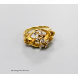 A 1970's? 18ct gold and seven stone diamond set modernist ring, size M, gross 8.7 grams.