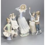 A Lladro figure of a ballet dancer, two dancers, newly-weds and lady in a bonnet, tallest 35cm