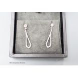 A modern pair of Rox 18ct white gold and diamond cluster set teardrop shaped loop drop earrings,