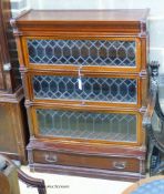 A Globe Wernicke serpentine mahogany four section bookcase. W.90cm D.33cm H.120cm.