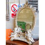 A late 19th century Louis XV style giltwood and gesso painted toilet mirror, width 76cm, height