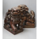 A pair of Chinese carved hardwood Buddhist lions, width 26cm height 37cm