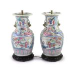 A pair of 19th century Chinese famille rose baluster vases, fitted as table lamps, on hardwood