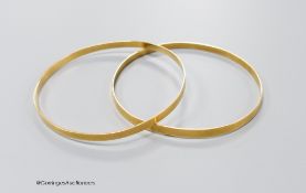 A pair of yellow metal bangles, stamped 18k, gross 18.1 grams.