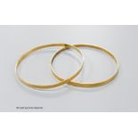 A pair of yellow metal bangles, stamped 18k, gross 18.1 grams.