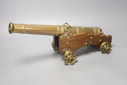 A 20th century bronze model cannon on wooden base, overall length 38cm