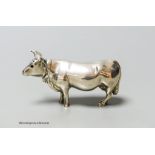 An Edwardian Hanau silver novelty silver pepper pot, modelled as a cow, Chester import marks for
