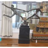 A large bronze of baton runners on faux marble base