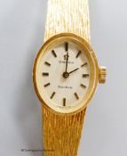 A ladys' 18ct gold Omega wristwatch,having oval cream dial and integral 750 mesh bracelet, gross