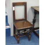 A 17th century Brittany oak back stool, height 84cm