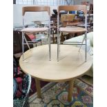 A circular beech breakfast table, depth 122cm, and two Italian chrome chairs.