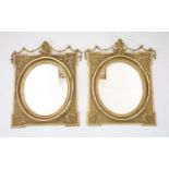 A pair of giltwood wall mirrors, of square form with oval plates, width 85cm, height 98cm