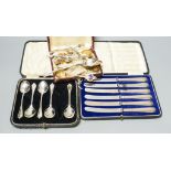 A cased set of 1920's silver teaspoons, a set of silver handled cake knives and sundry small silver